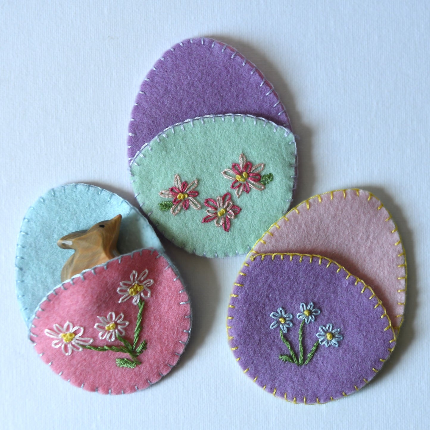 Floral hand embroidered reuseable Easter egg pouches made from 100% wool felt.