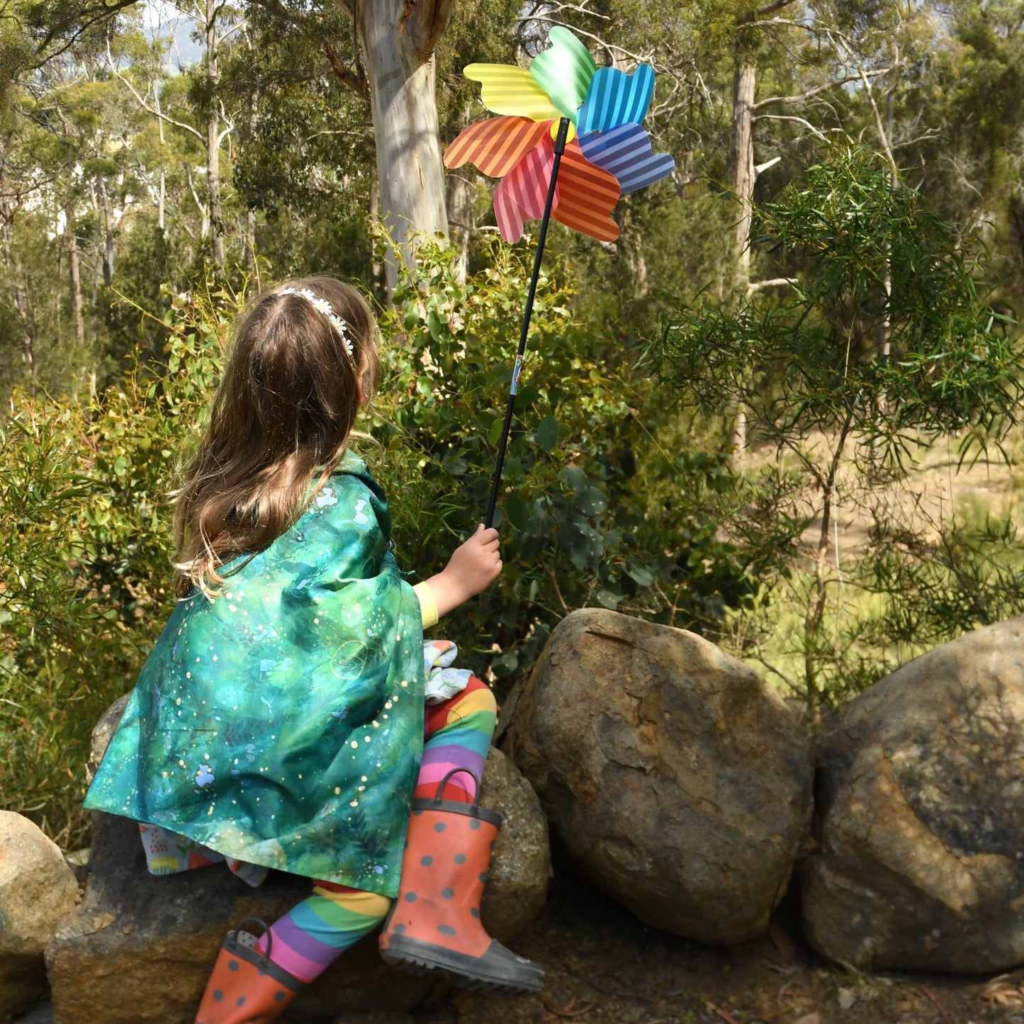 Forest play cloth used as a cape for child during outdoor imaginative play.