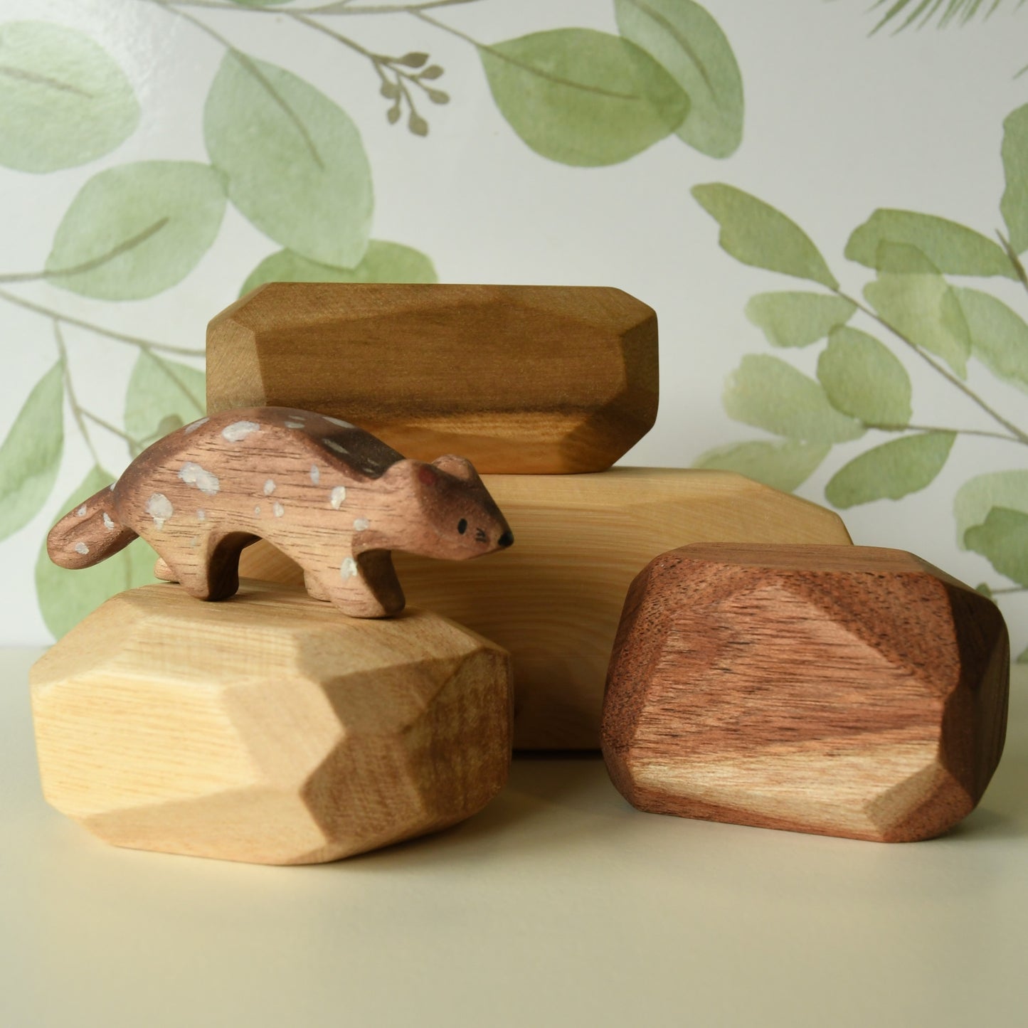 Natural stacking rock wooden block set shown next to wooden Australian animal toy.