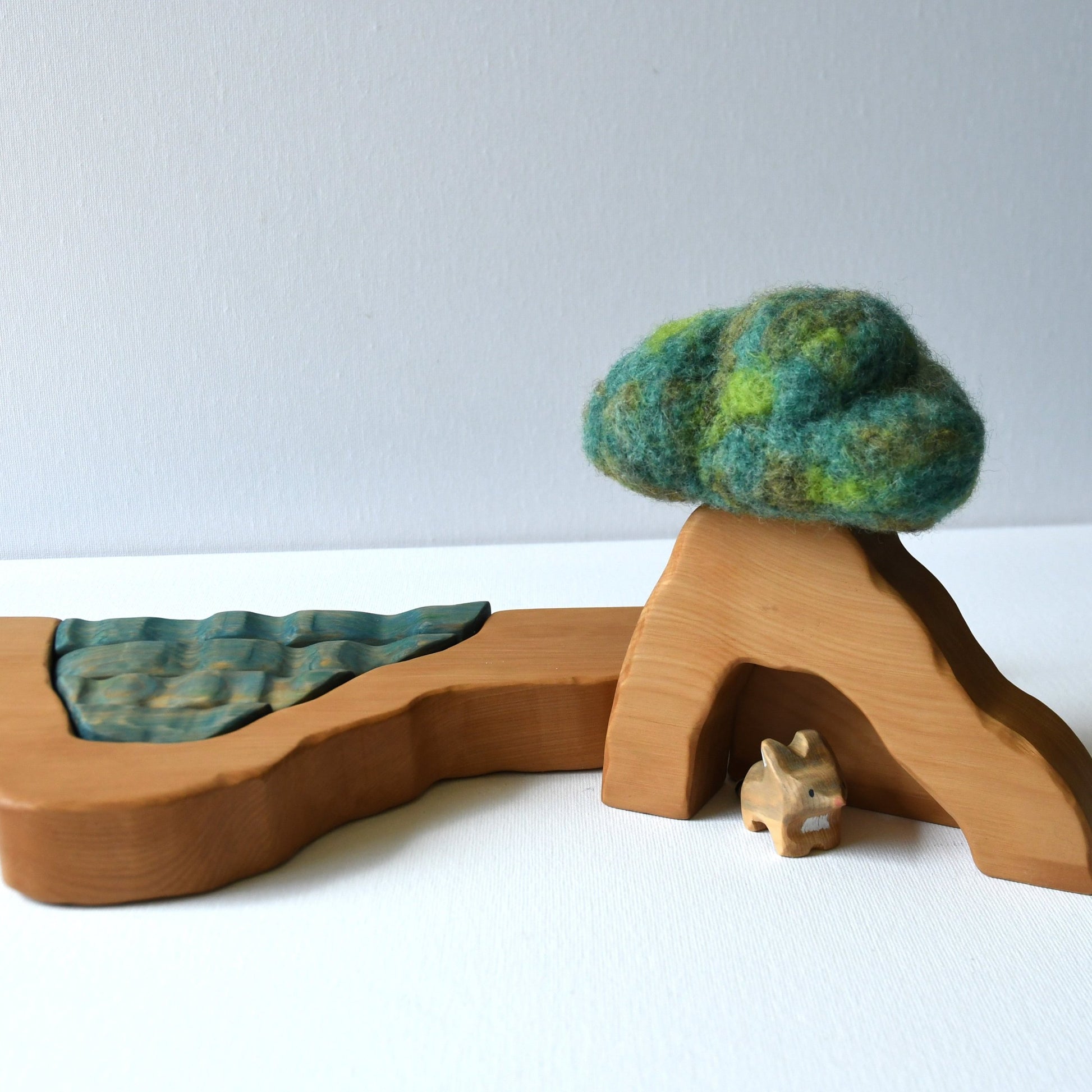 Wooden cave stacker toy with waterfall pond and felt bush