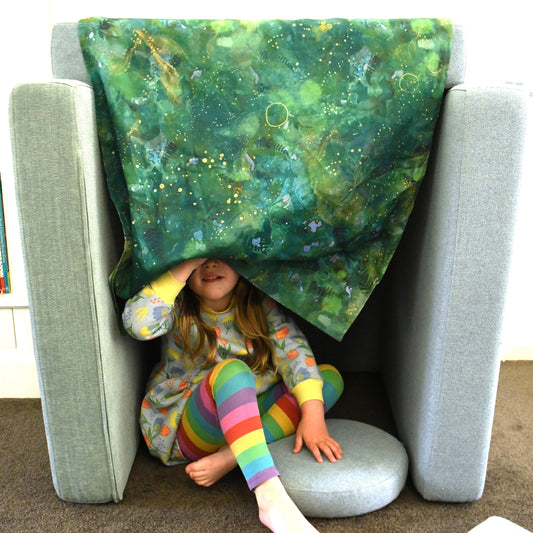 Forest play cloth used to build a cubby with play couch.