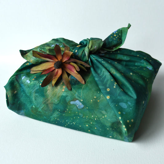 Green forest themed cotton play cloth used as reuseable gift wrap for Christmas.