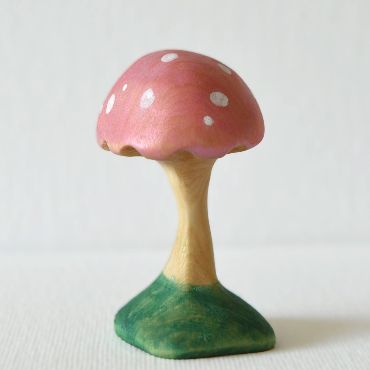 Wooden pink mushroom toy and fairy garden decoration.