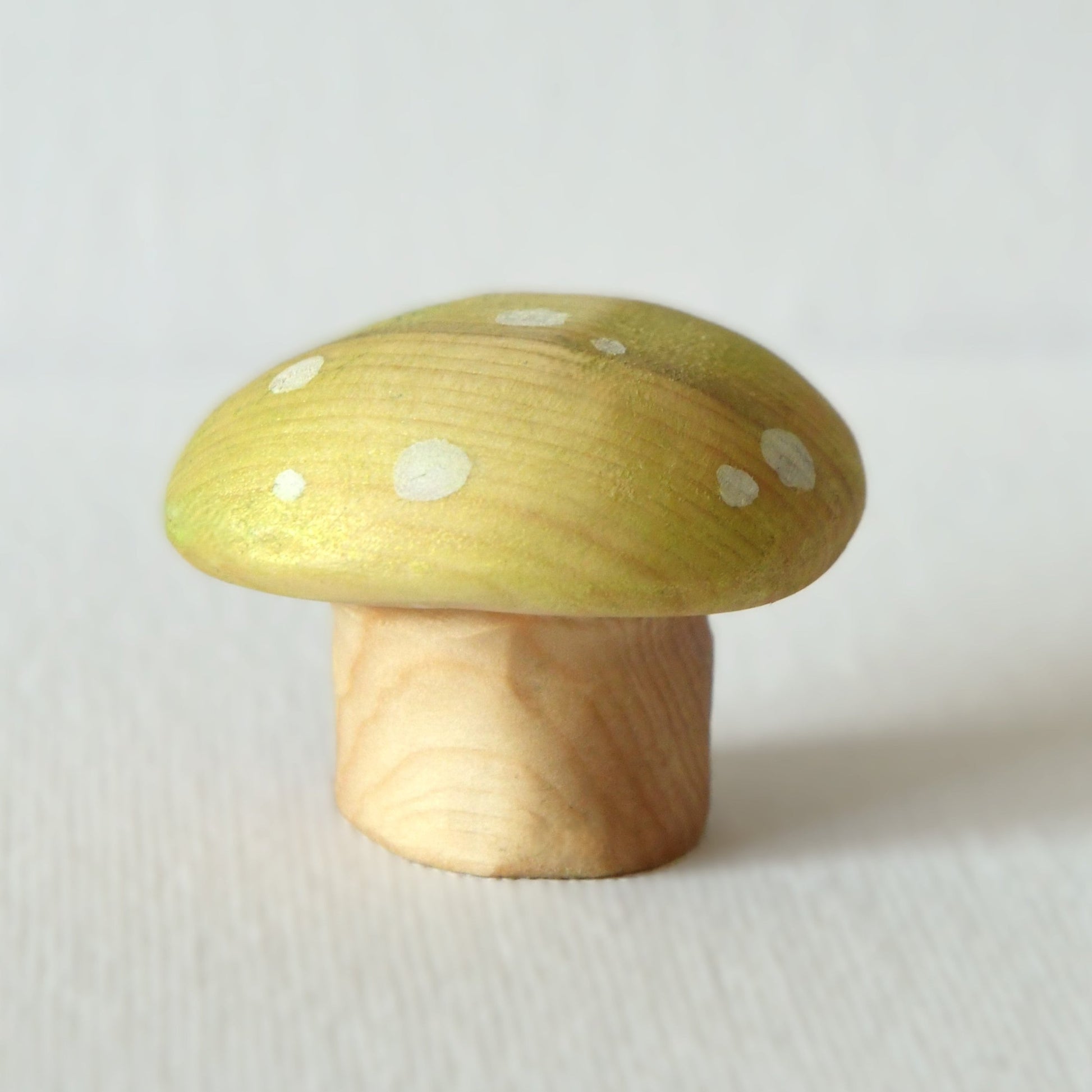 Wooden yellow mushroom toy and fairy garden decoration.